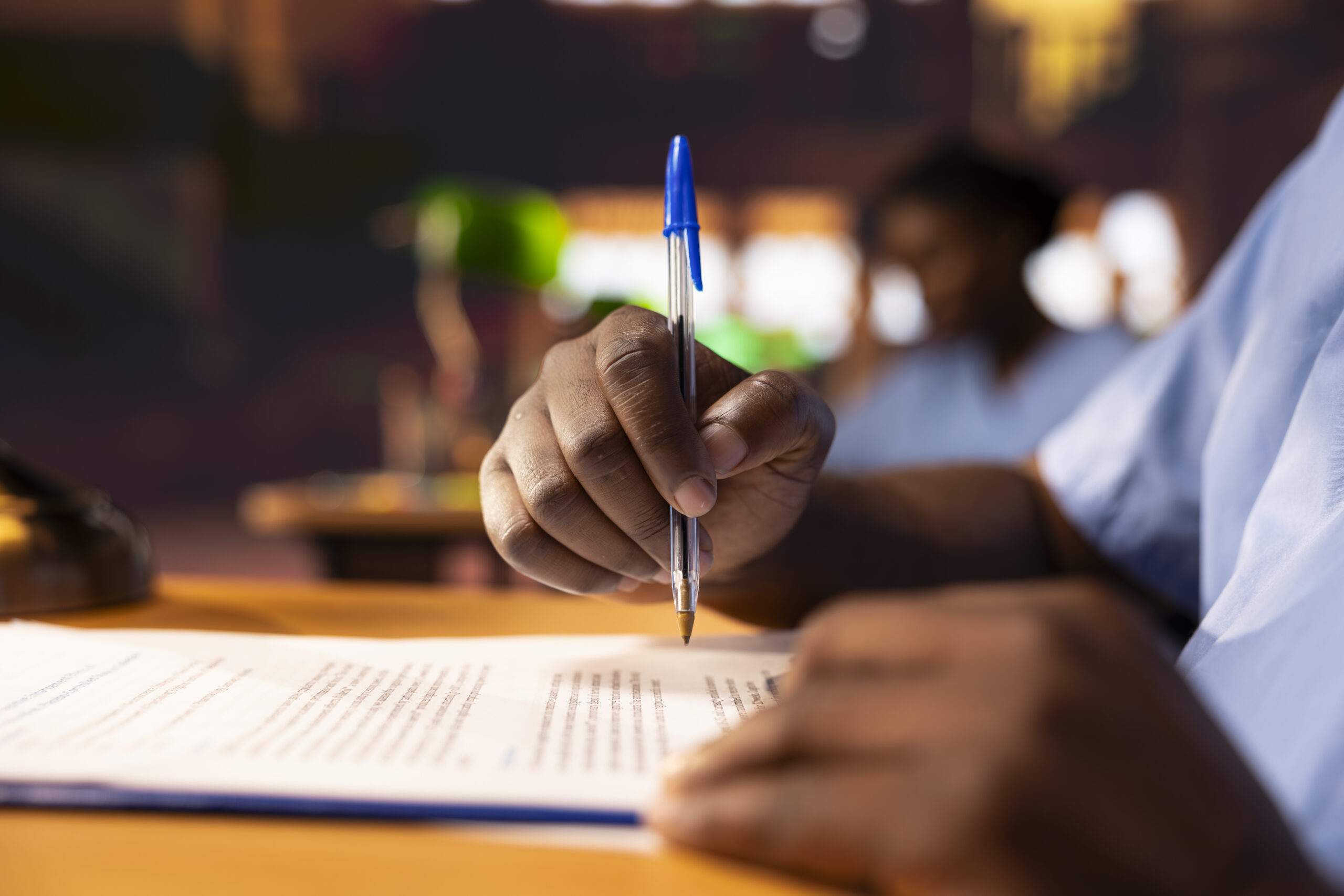 Home black male pupil makes notations about practice methods to prepare for an exam